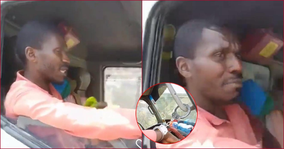 The man was filmed cuffed against the driver's grab handle after beiung accused of blocking the road.